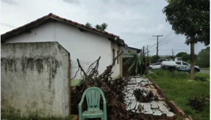 Casa com danos estruturais e destroços após um temporal.