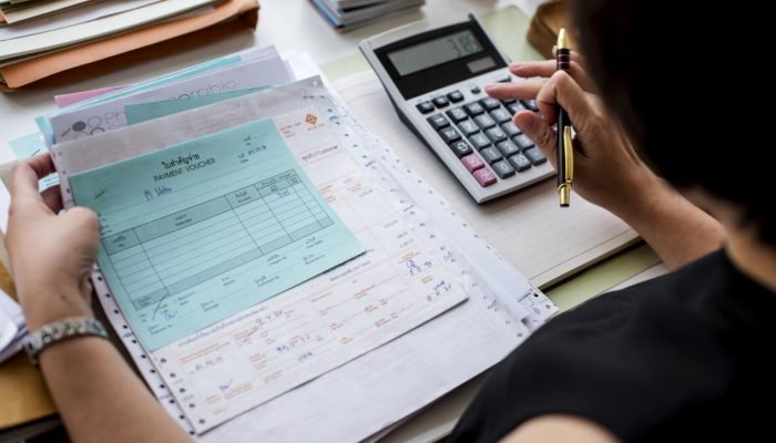 asian-woman-working-through-paperwork