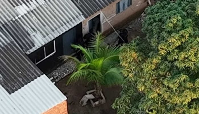 Agentes de segurança em operação tática em área residencial densa.
