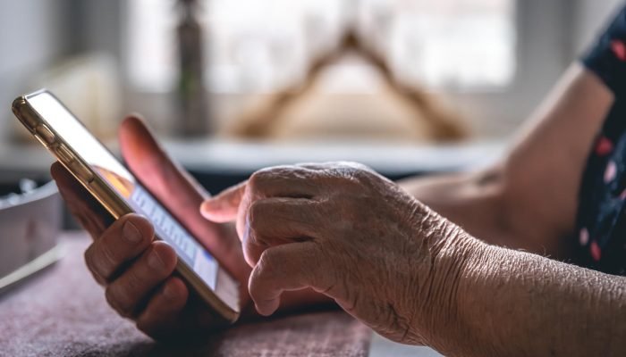 hands-elderly-woman-holding-mobile-phone