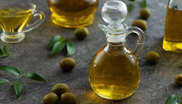 high-view-bottles-filled-with-olive-oil-marble-background