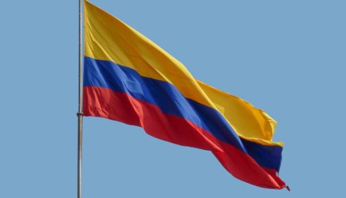 the colombian national flag in front of blue sky
