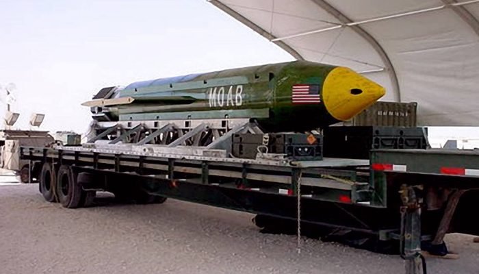 Bomba MOAB verde e amarela em cima de um caminhão.