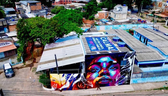 Telhado na Cidade de Deus diz: "Aqui tem crianças, sonhos e famílias"