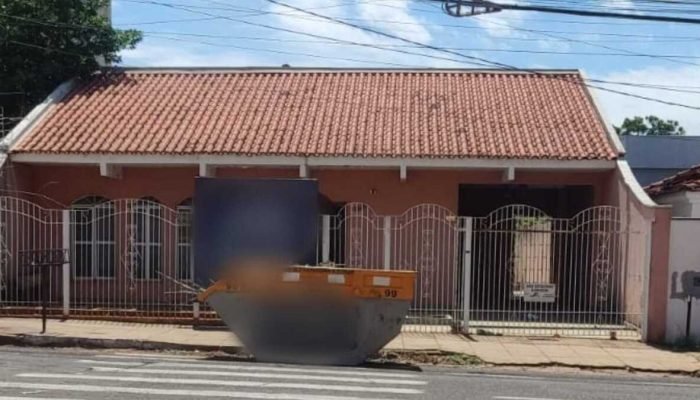 Caçamba sobre faixa de pedestres dificulta travessia em frente a escola em Campo Grande